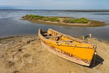 Fototapeta premium Old fishing boats stranded on the shore of the Delta del Ebro