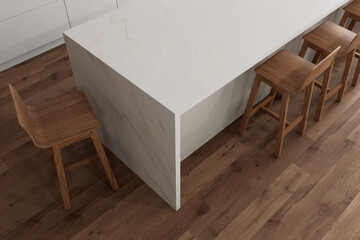 This is a modern kitchen designed with a minimalist white island paired with wooden stools