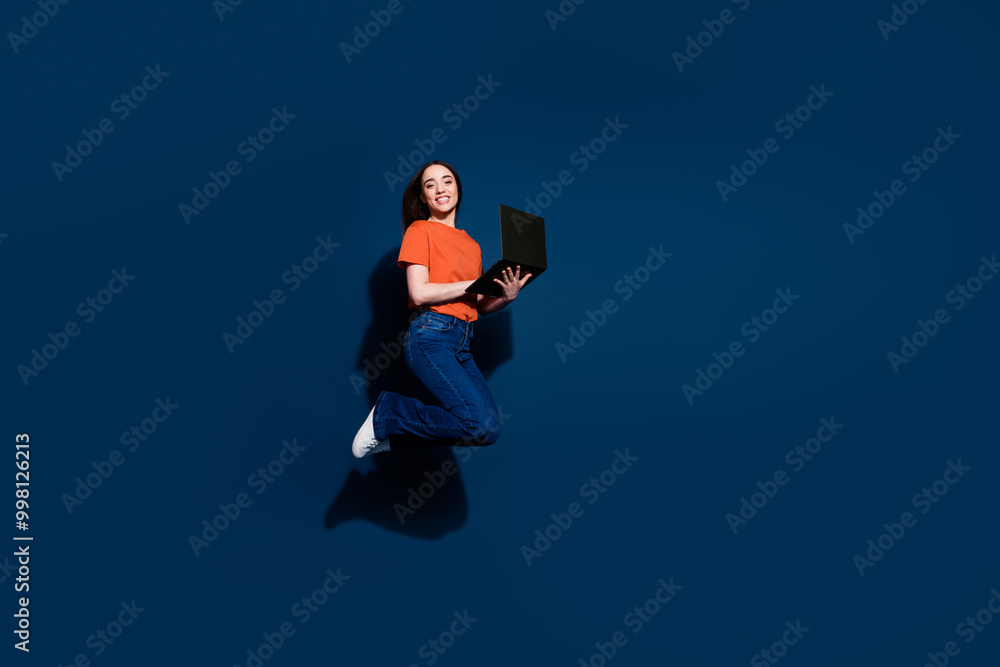 Poster Photo of glad positive cheerful woman wear trendy clothes hold macbook isolated on dark blue color background