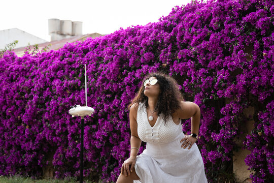 Beautiful Woman in White Dress Playing the Theremin in Scenic Garden Setting