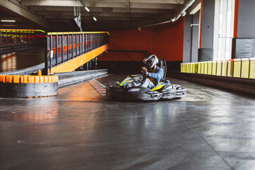 Go-Kart Racer in Action on Indoor Track © PintoArt