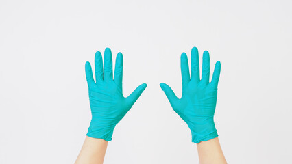 Hands is wear aqua mint green latex gloves on white background.
