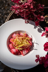 A vibrant dish of pasta coated in creamy beetroot sauce and topped with crispy zucchini. This...