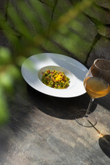 A hearty plate of spinach spätzle topped with crispy speck. This flavorful dish combines the richness of traditional German dumplings with the smoky taste of cured meat.