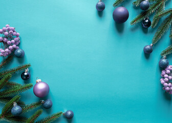 Christmas card concept with fir tree branches, presents, snowflakes, decorations on blue background.
