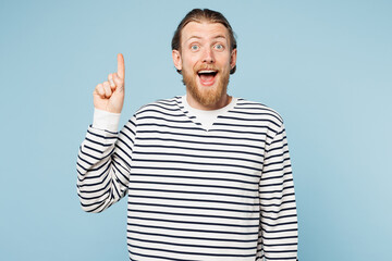 Young proactive happy man he wears striped sweatshirt casual clothes holding index finger up with...
