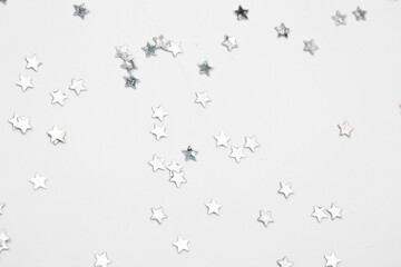 sparkles silver stars on white background with text place- Image