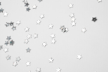 sparkles silver stars on white background with text place- Image