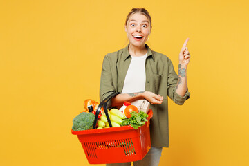 Young fun woman wear casual clothes hold bag basket for takeaway mock up with food products holding...
