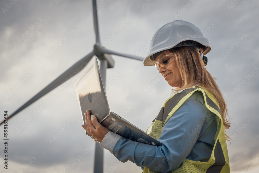 Poster a skilled female engineer analyzes data at a wind turbine site, demonstrating her expertise in mergi