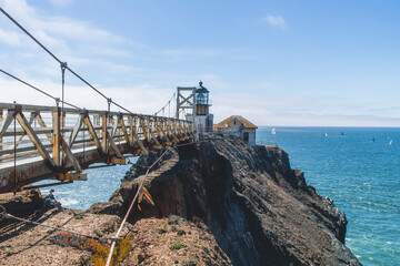 Point Bonita Lighthouse in California, which sits on a rugged cliff, accessible by narrow suspension bridge