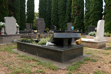 granite tombstones in cemetery with flowers