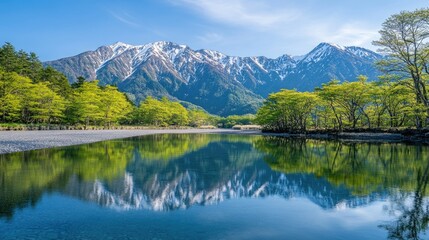 A stunning view of Kamikachiaes Azusa River reflecting the fresh green trees and the majestic Hotaka Mountains, creating a peaceful and picturesque landscape.