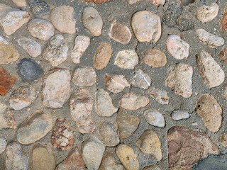 Blue and gray sea pebble-stone wall texture. © Roberto