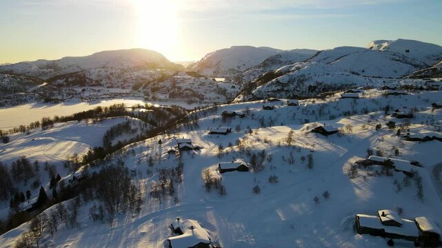 Drone shot over Sirdal Agder Norway at winter with blue skies and low sun