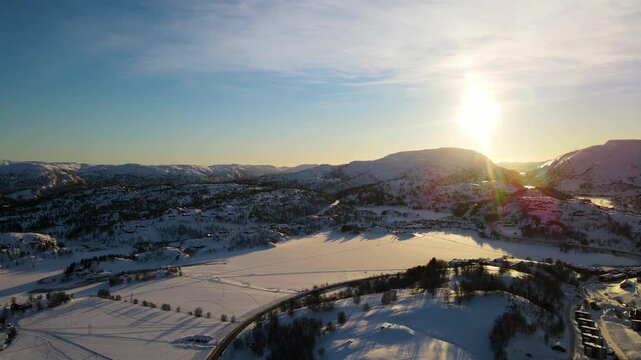 Drone shot over Sirdal Agder Norway at winter with blue skies and low sun