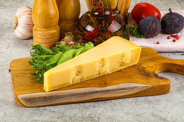 Hard parmesan cheese triangle over board