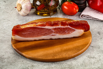 Piece prosciutto crudo over board
