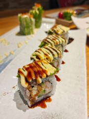 Top view of assorted sushi. Rainbow sushi roll, uramaki, hosomaki and nigiri.