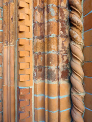 Background of red columns in different geometric shapes as wall decoration.