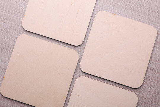Wooden square drink coasters on the table