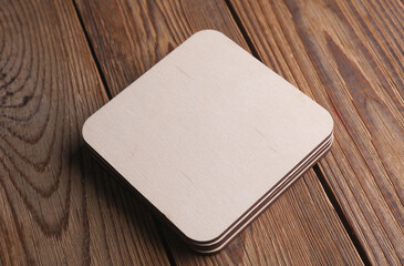 Wooden square drink coasters on the table