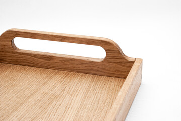 Elegant solid oak wood tray with dovetail joints and carved handles on the sides for easy carrying closeup view on white background