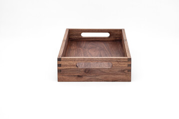 Solid walnut wood tray with dovetail joints and cutout handles on the sides for easy carrying on white background