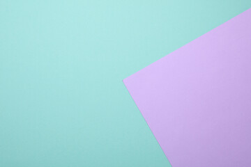 Purple sheet of paper on a mint green background