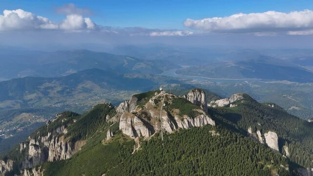 Drone flies over Toaca peak with visible ladder and antennas
