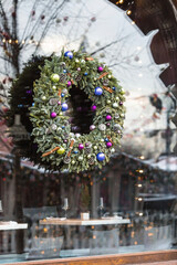Christmas decorations on the streets of Moscow. Christmas holidays, winter landscape. A beautiful Christmas wreath on the window.
