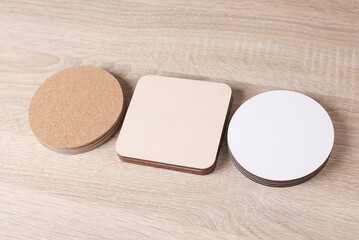 Cork, white, wooden coasters for drinks on wooden table
