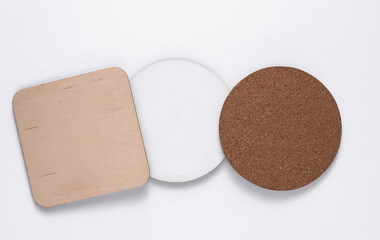 Cork, white, wooden coasters for drinks on white background