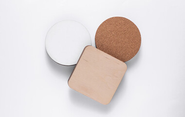 Cork, white, wooden coasters for drinks on white background