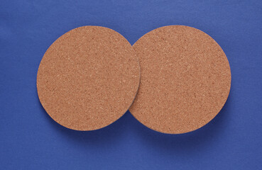Cork coasters for drinks on blue background