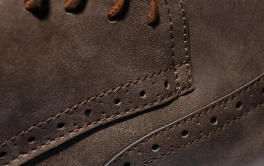 Close-up detail of brown leather brogue boots