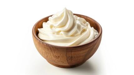 A wooden bowl filled with creamy whipped topping, ready for dessert or decoration