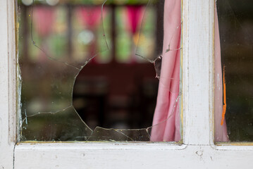 The window glass of a house is broken