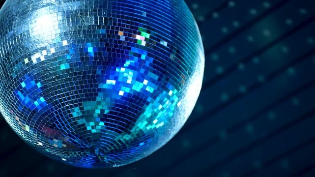 A large mirrored disco ball spins and reflects light in the club