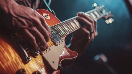 Obraz premium Close-up of hands playing a guitar on stage, Musician playing the guitar at a concert