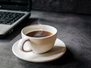 Relax during business work concept, americano coffee cup and black coffee cup aromatic and laptop computer in morning