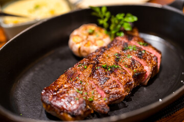 Beef rib eye steak slice on the cast iron