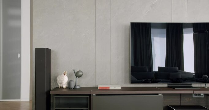 Contemporary interior design of the living room with TV chest of drawers. Cozy Modern Furniture Design. Luxury Elegant Room. Modern interior living room with simple commode. Minimalist Home Interior. 