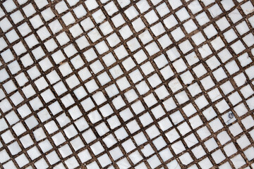 Texture of the old tile wall. Square white small tiles on concrete texture