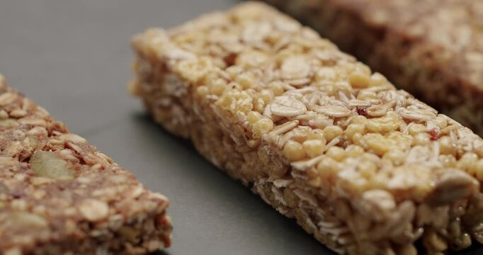 Delicious close-up of healthy granola bars featuring oats and seeds. Ideal for snack time or post-workout energy boost. Perfect for health-conscious individuals. Assorted Granola and Cereal Bars