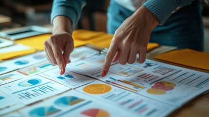 Hands Pointing at Business Strategy Charts