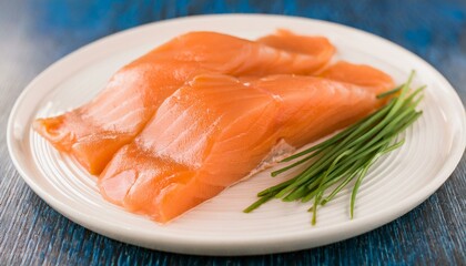 Smoked salmon on a white plate with chives.