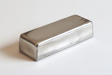 Nickel ingot is resting on a white backdrop, showcasing its metallic sheen and industrial use