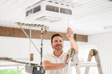 A men inspector or Fixing a garage heater