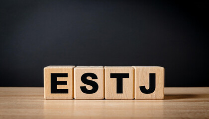 Wooden cubes with abbreviation ESTJ. Extraverted, Sensing, Thinking, Judging. Personality type.